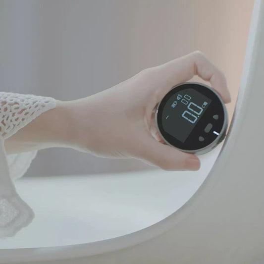 Electronic measuring tape with digital display held against surface for precise measurement