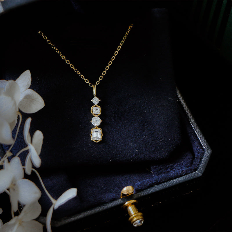 Necklace Woman Collarbone Chain Personality Pendant in a jewelry box with a floral decoration.