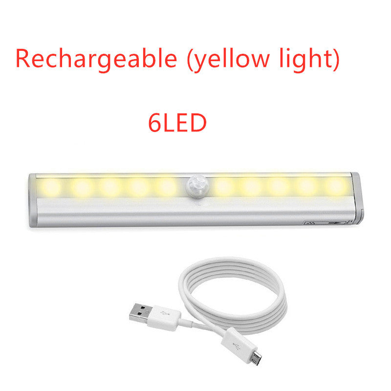 LED sensor light with rechargeable yellow light and USB cable, perfect for cabinets and other spaces.