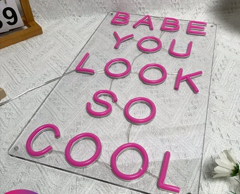 Neon LED Light sign saying 'Babe You Look So Cool' in vibrant pink letters on clear background.