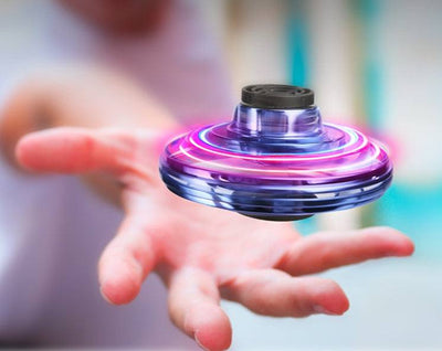 Mini fingertip gyro toy drone with RGB lights spinning above hand for decompression and interactive play