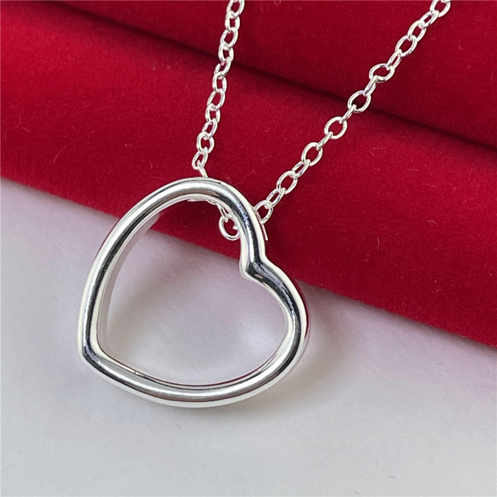 Heart necklace for women with elegant silver heart pendant on a chain, symbolizing style and timeless fashion.