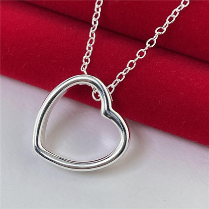 Heart necklace for women with elegant silver heart pendant on a chain, symbolizing style and timeless fashion.