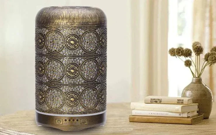 Portable Dyson air purifier with intricate bronze design on wooden table in bright room