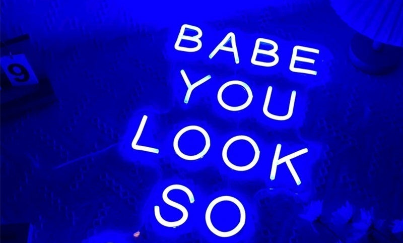Neon LED Light sign saying 'Babe, you look so' in vibrant blue illumination.