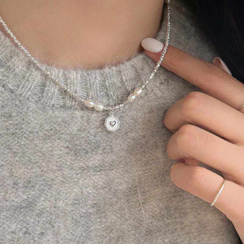 Fashion Love Pearl Necklace with sterling silver heart pendant and freshwater pearls on a woman's neck