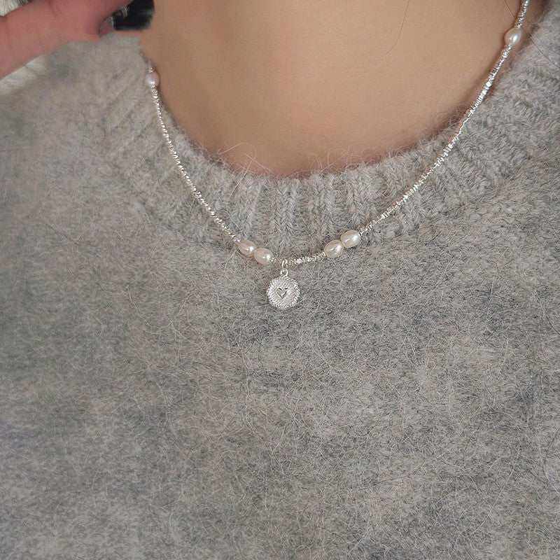 Fashion Love Pearl Necklace with silver heart pendant and freshwater pearls on a woman's neck