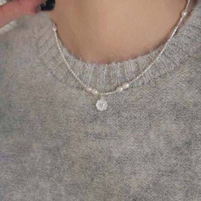 Fashion Love Pearl Necklace with silver heart pendant and freshwater pearls on a woman's neck