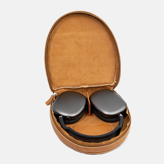 Brown full-grain leather case open with AirPods Max inside, soft lining and cable pocket visible