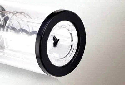 Close-up of black rim and spiral corkscrew mechanism of electric wine opener tool