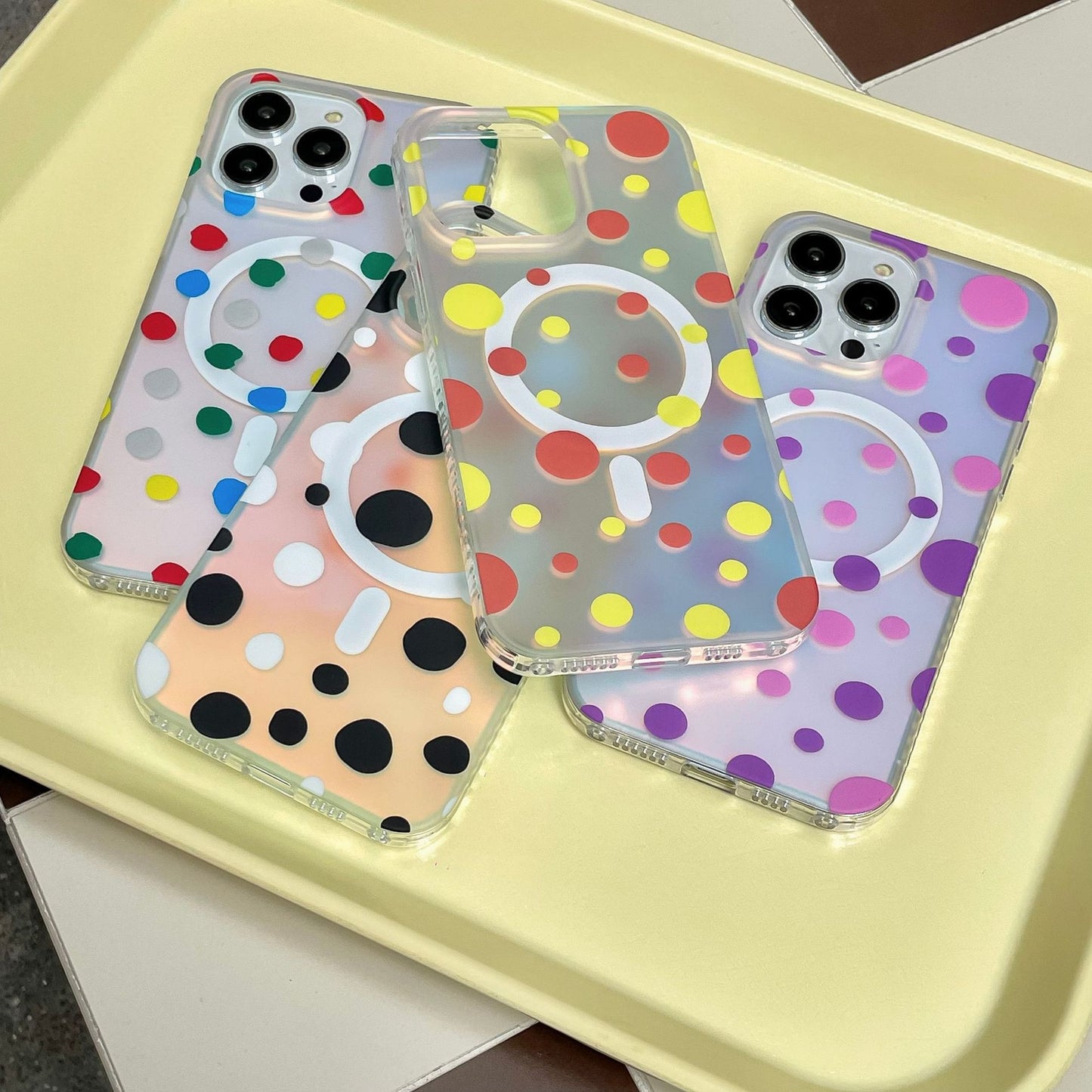Magnetic Phone Case Wave Point Phone Cases with polka dots in various colors on a tray.