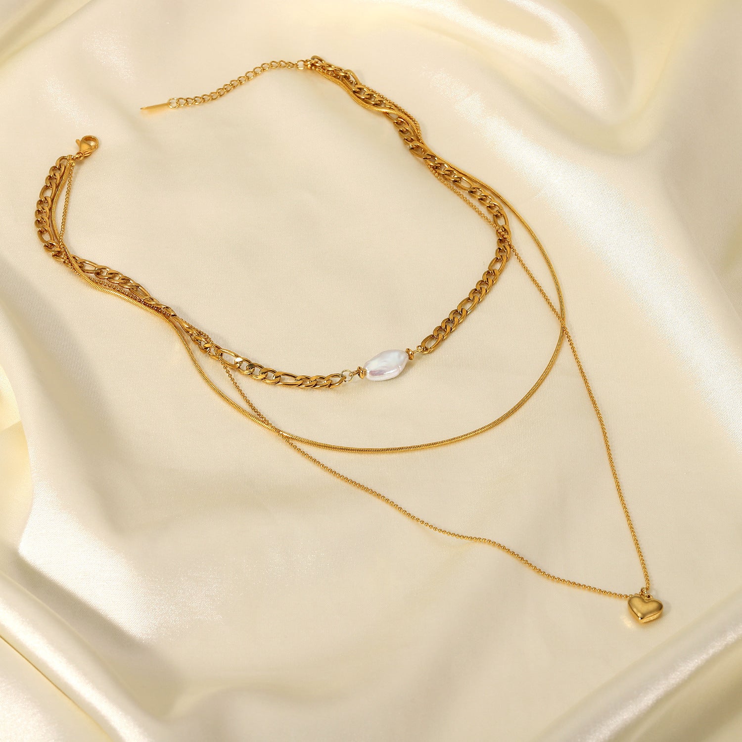 Pearl heart-shaped necklace for women on elegant satin background, showcasing its delicate design and timeless beauty.