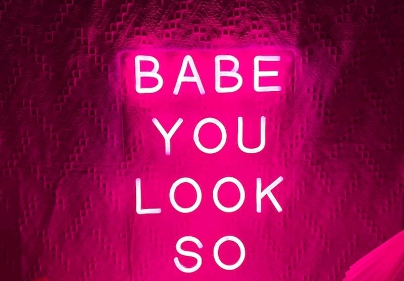 Neon LED Light sign with the phrase 'Babe You Look So' in pink illumination, perfect for vibrant home decor.