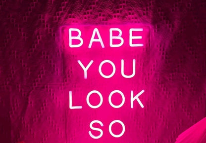 Neon LED Light sign with the phrase 'Babe You Look So' in pink illumination, perfect for vibrant home decor.