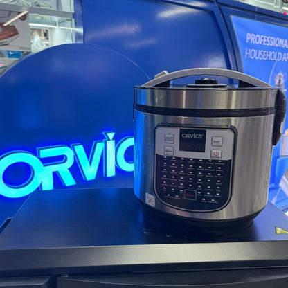 Electric Pressure Cooker Household Non-stick Rice Cooker displayed on a table with blue sign in the background.