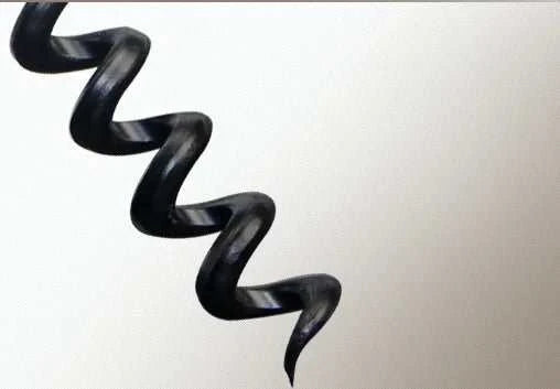 Close-up of black corkscrew spiral of electric wine opener tool